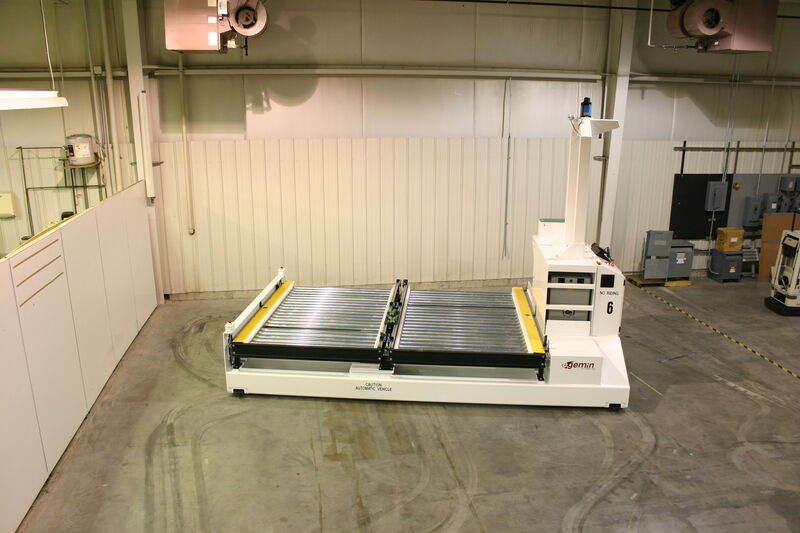 Unit load AGVs transporting heavy loads in a production facility